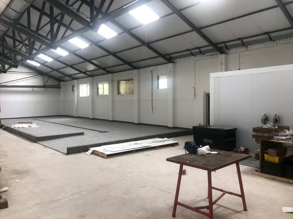 Commercial refurbishment | work underway in a warehouse, small tables 