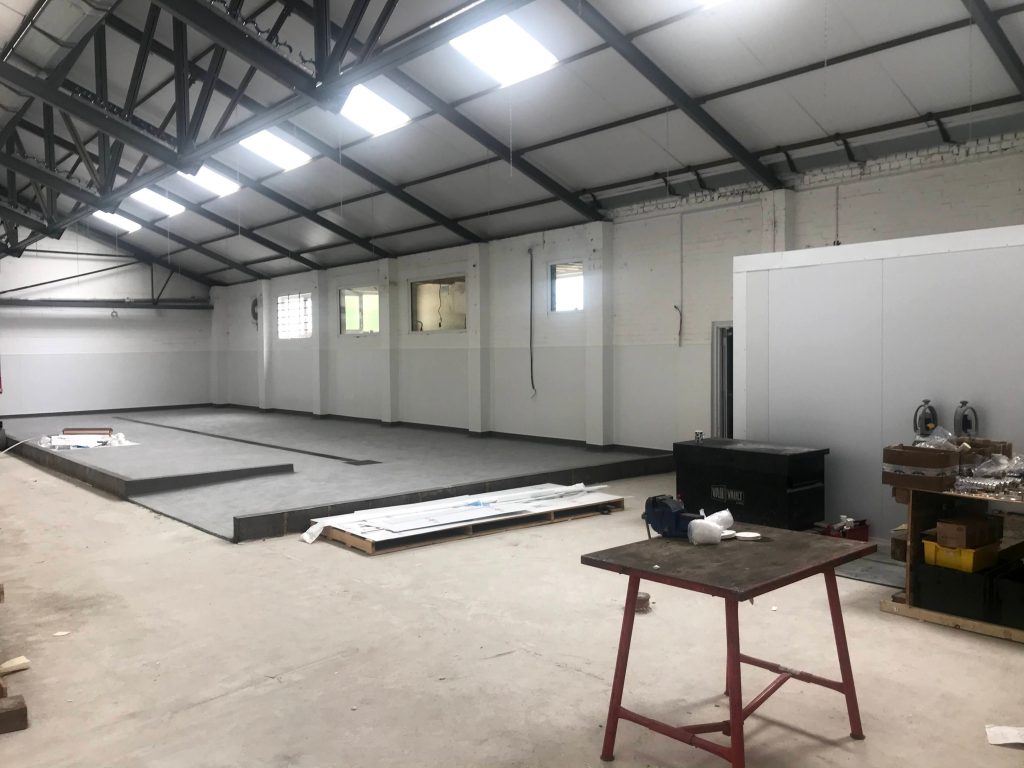 Commercial refurbishment | work underway in a warehouse, small tables