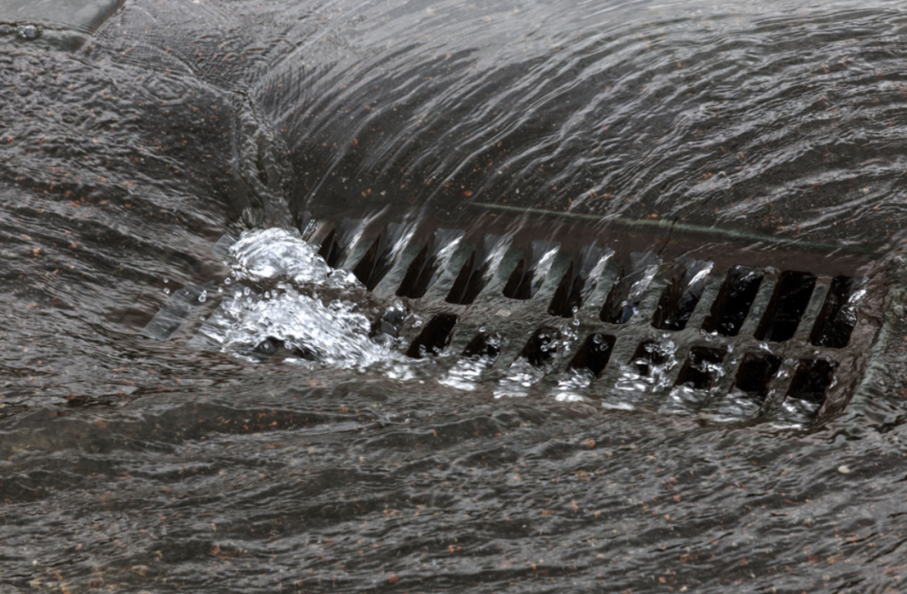 Drainage system | Running water into a metal grate.
