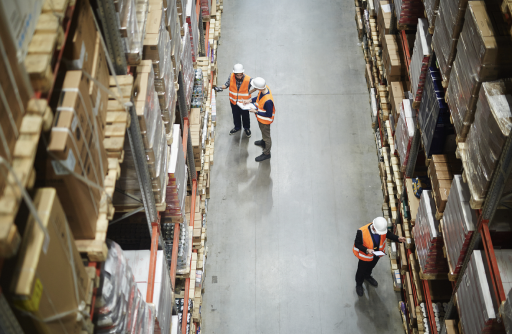 Industrial warehouse refurbishment | People inspecting pallets in a warehouse.
