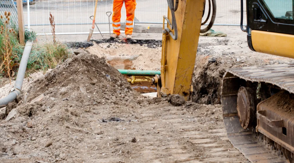 Groundworks companies near me | Ground being excavated by digger.